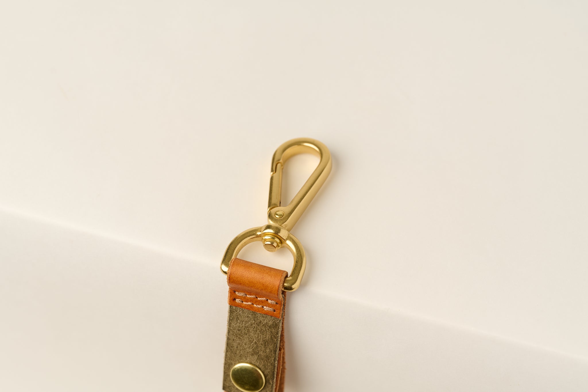 Anya Roux contemporary leather keychain on white background.