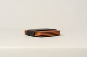Brown leather coaster set shown in black storage sleeve.