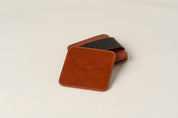One leather coaster on top of set.