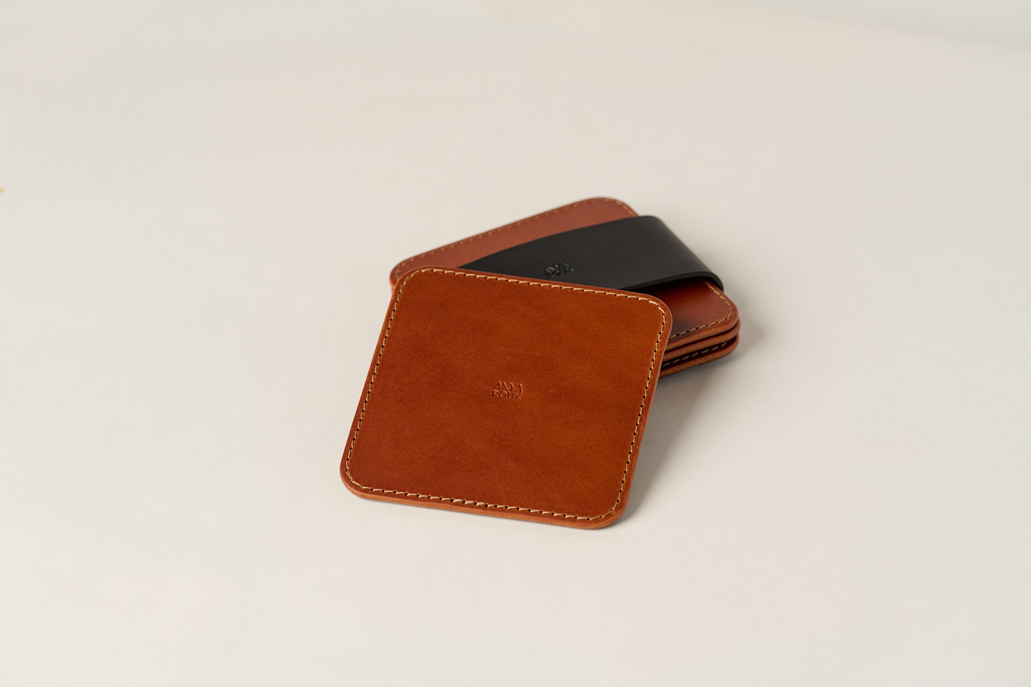 One leather coaster on top of set.