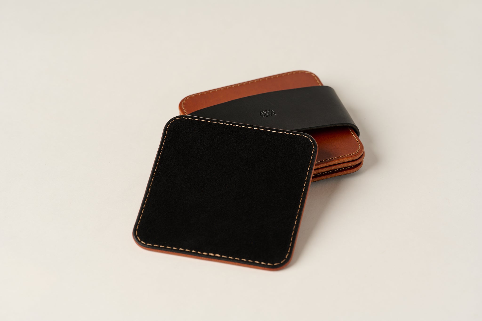 Black suede underside of coaster shown.