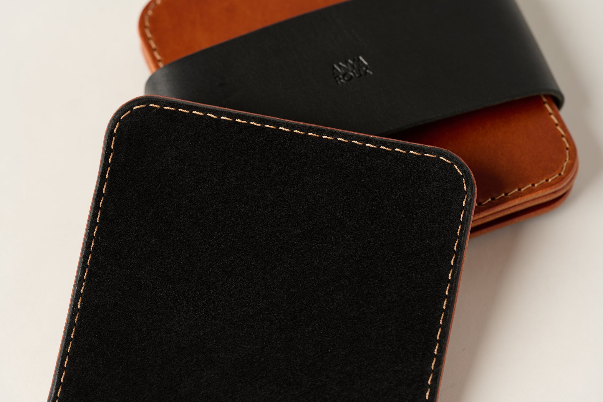 Close up of black suede on bottom of coaster.