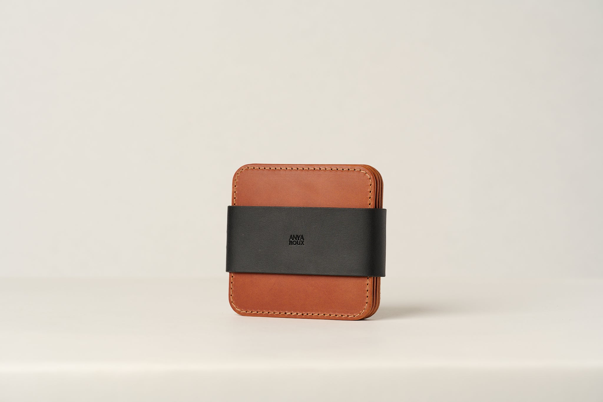 Set of 4 brown leather coasters.
